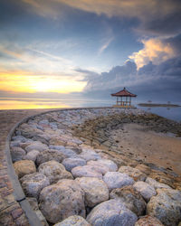 Scenic view of beach against sky during sunset