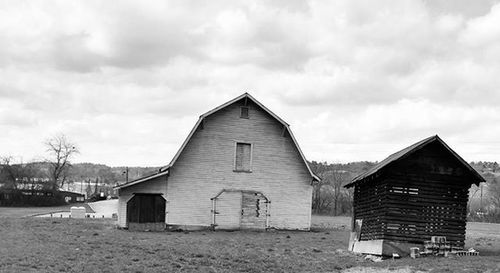 Houses against cloudy sky