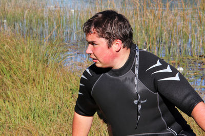 Man looking away while standing on land