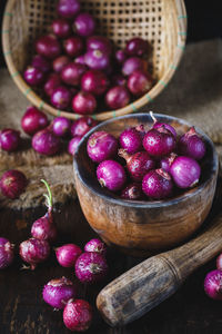 Close-up of wet shallots with mortar and pestle on table