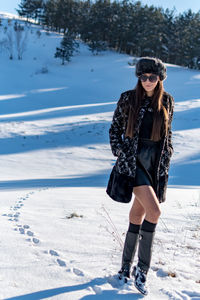 Full length of woman on snow field