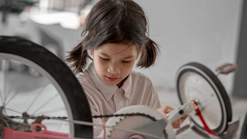 Girl looking through bicycle