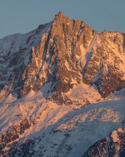 Scenic view of snowcapped mountains against clear sky