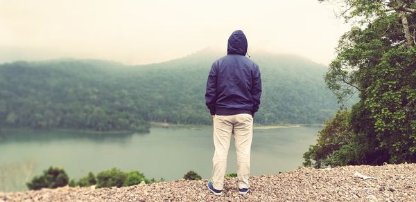 Rear view of man looking at view of mountain