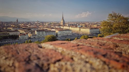 Tilt-shift image of cityscape against sky