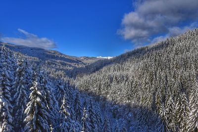 Scenic view of mountains against blue sky