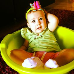 Portrait of cute girl sitting on floor