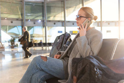 Midsection of woman using mobile phone