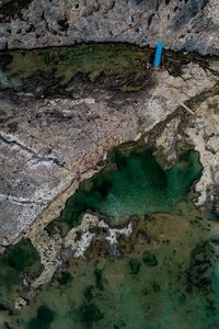 High angle view of rocks by sea