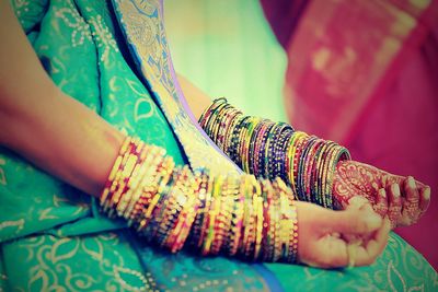 Low section of person wearing bangles