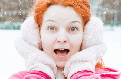 Close-up portrait of woman screaming during snowing