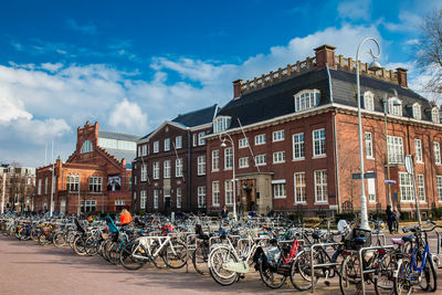 Bicycles parked on street against buildings in city