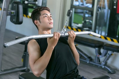 High angle view of young man exercising in gym