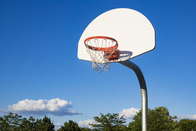 Basketball hoop on blue sky background in the school yard