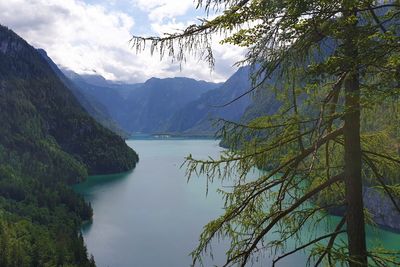 Scenic view of lake by mountains against sky