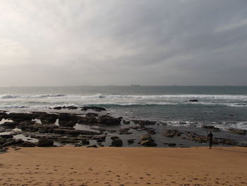 View of calm beach against the sky