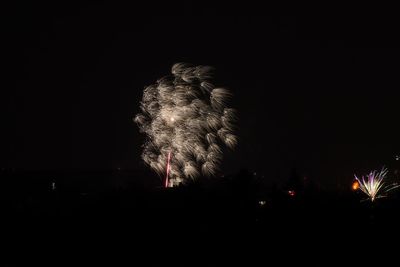 Low angle view of firework display at night