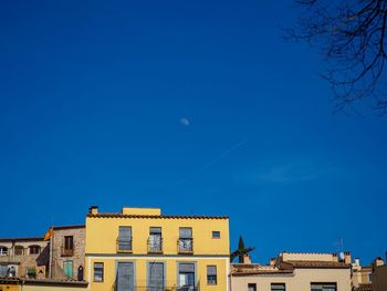 Low angle view of buildings against blue sky