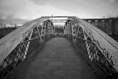 Bridge against cloudy sky