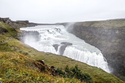 Scenic view of waterfall against clear sky