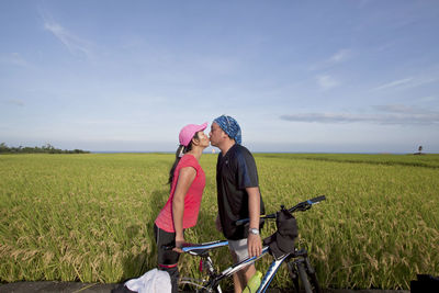 Rear view of woman standing on field