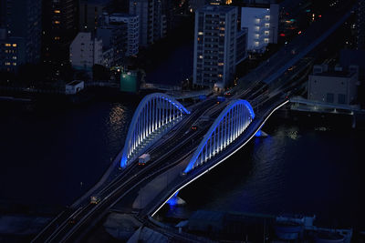 High angle view of illuminated bridge and buildings at night