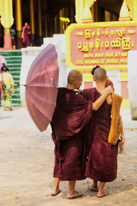 Rear view of men walking in temple