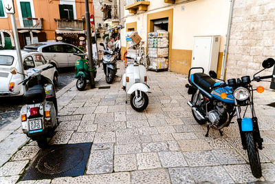 Bicycles parked on footpath by street in city