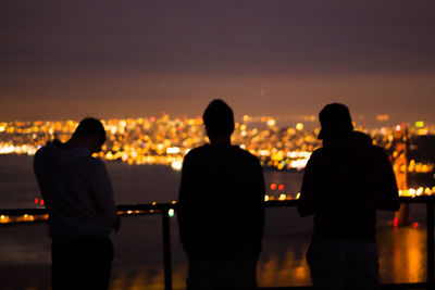 Silhouette people standing at night