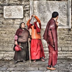 Full length of woman leaning on wall