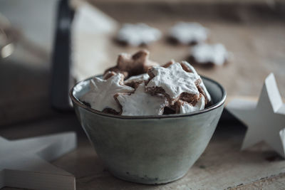 Close-up of bowl full of cookies on table