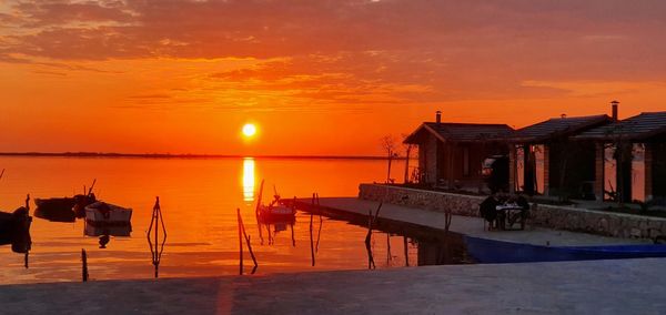 Scenic view of sea against orange sky