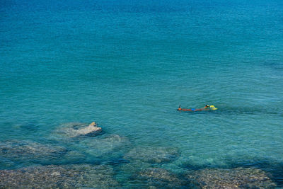 High angle view of people swimming in sea