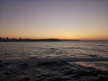 Scenic view of sea against clear sky during sunset