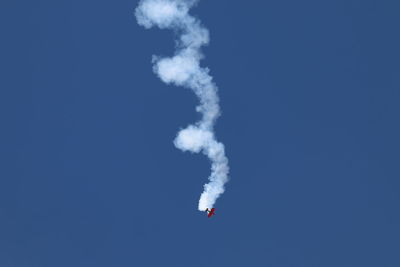 Low angle view of airplane against clear blue sky