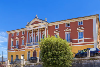 Low angle view of building against clear blue sky