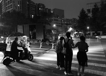 People on city street at night