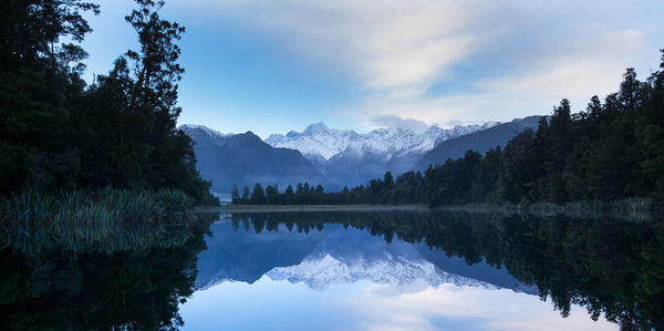 Scenic view of lake and mountains against sky