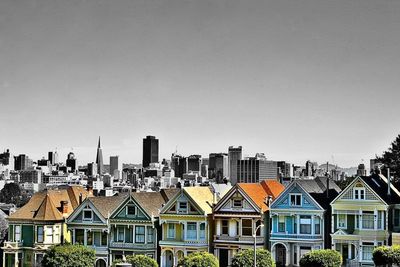 Buildings in city against clear sky