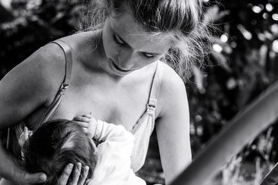 Midsection of mother and daughter outdoors