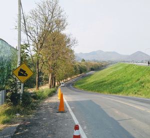 Road passing through landscape against clear sky