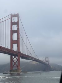 Low angle view of golden gate as the morning fog dissipates 
