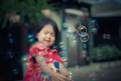 Close-up of bubbles by girl