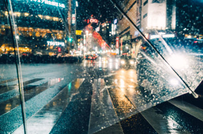 Reflection of city on wet windshield in rainy season