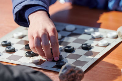 Midsection of man playing chess