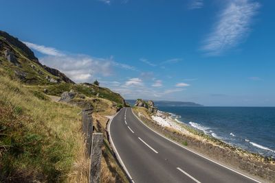 Road by sea against sky