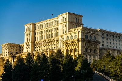 Low angle view of building against clear blue sky