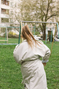 Rear view of woman standing on grass