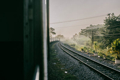 Railroad tracks seen through train window