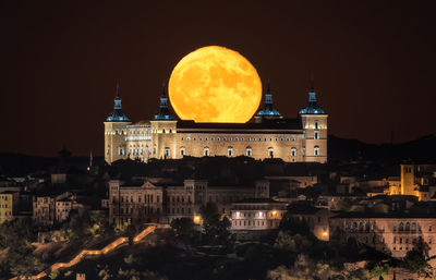 View of illuminated buildings against sky at night